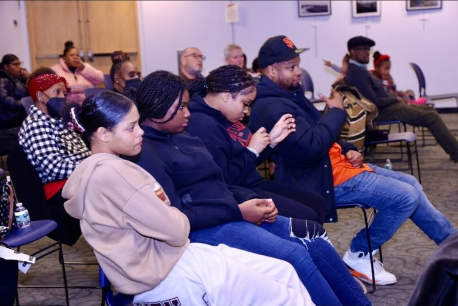 Youth and families watching the Kwanzaa program