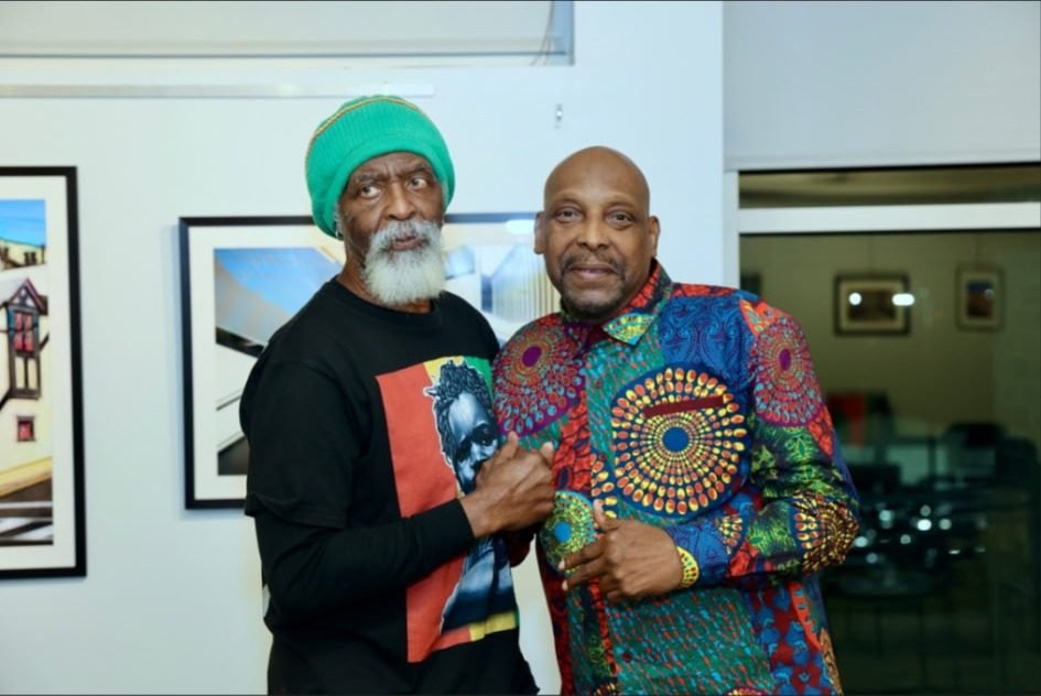 Two elders posing together at the Kwanzaa celebration