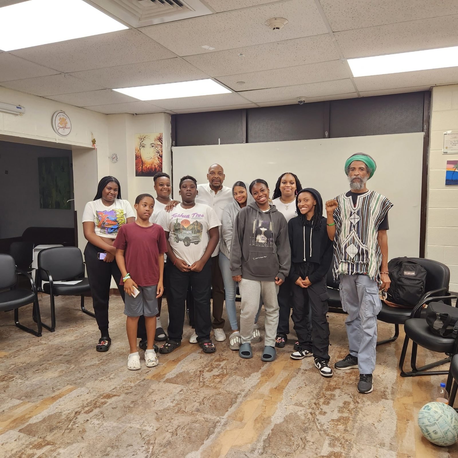 CCWW youth standing together with a community elder
